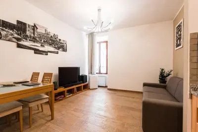 a living room with a table and a couch at TrinitaDeiMonti Guest House in Rome