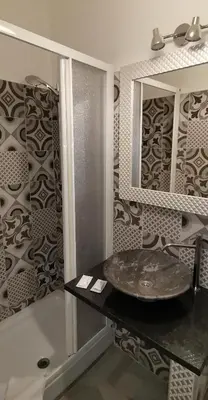 a bathroom with a sink and a mirror at Friendship Place in Rome