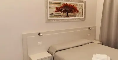 a bedroom with a bed and a painting on the wall at Friendship Place in Rome