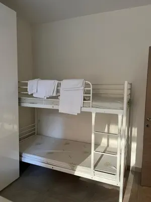 a white bunk bed in a room with towels at San Pietro house in Rome