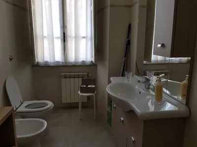 a bathroom with a sink and a toilet and a mirror at San Pietro house in Rome
