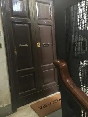 a wooden door in a room with a chair at ROMA - Loft Campo de' Fiori - Appartamento Campo de' Fiori - LE CUGINE in Rome