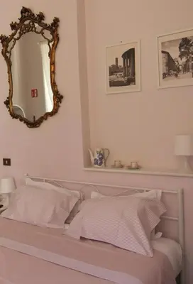 a bedroom with a bed with a mirror on the wall at ROMA - Loft Campo de' Fiori - Appartamento Campo de' Fiori - LE CUGINE in Rome