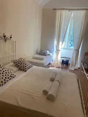 a bedroom with two beds and a window at CK Rooms in Rome