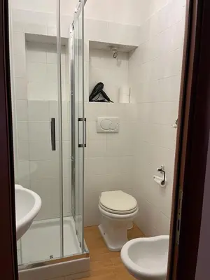 a bathroom with a shower and a toilet and a sink at CK Rooms in Rome