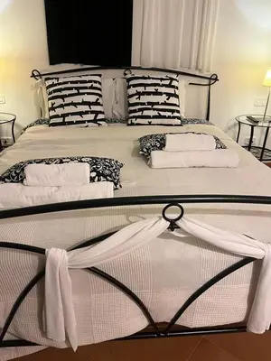 a large bed with black and white pillows on it at CK Rooms in Rome