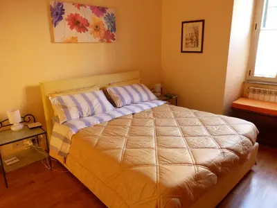 a bedroom with a large bed with two pillows at Lugiadra in Rome