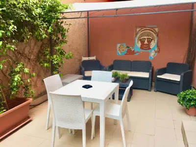 a white table and chairs on a patio at Chic 'N Charme Trastevere Terrace in Rome