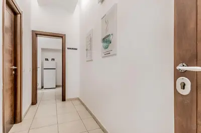 a hallway with a door and a white refrigerator at Vatican City Guest House in Rome