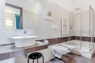 a bathroom with a sink and a toilet and a shower at Vatican City Guest House in Rome
