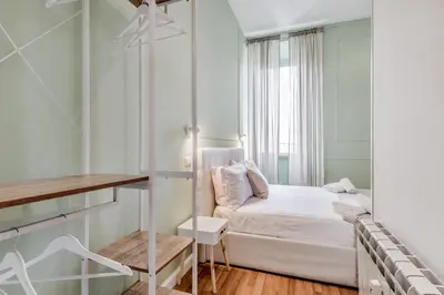 a small bedroom with a bed and a window at Vatican City Guest House in Rome