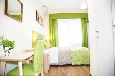 a bedroom with a bed and a desk and a table at Vatican Suite 383 in Rome