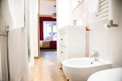 a white bathroom with a sink and a toilet at Vatican Suite 383 in Rome