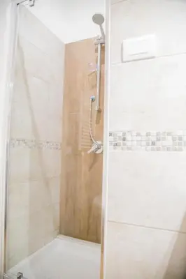 a shower with a glass door in a bathroom at Vatican Suite 383 in Rome