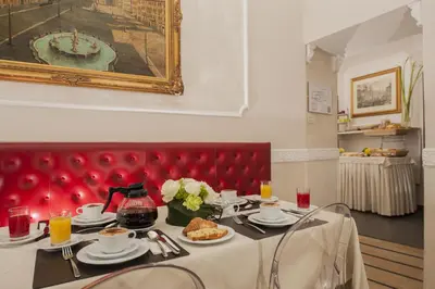 a table with plates of food on top at Hotel Navona in Rome