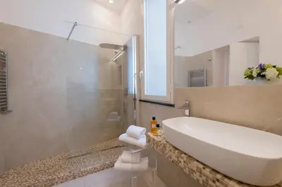 a bathroom with a white sink and a shower at Hotel Navona in Rome