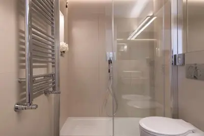 a bathroom with a shower with a toilet and a sink at Hotel Navona in Rome