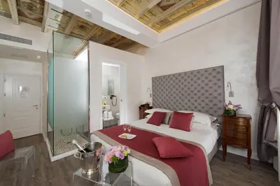 a bedroom with a large bed with red pillows at Hotel Navona in Rome