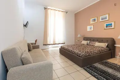 a living room with a bed and a couch at Il sole del Vaticano in Rome