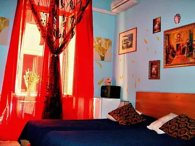 a bedroom with a red curtain and a bed at B&B Cappellini in Rome