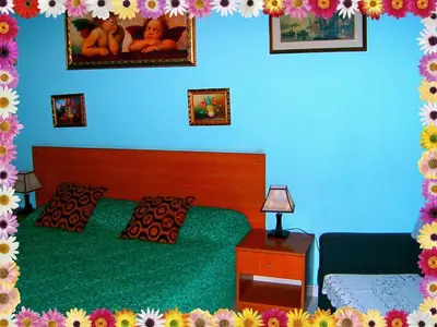 a bedroom with two beds and a blue wall with flowers at B&B Cappellini in Rome