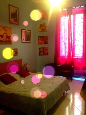 a bedroom with a bed with pink lights on it at B&B Cappellini in Rome