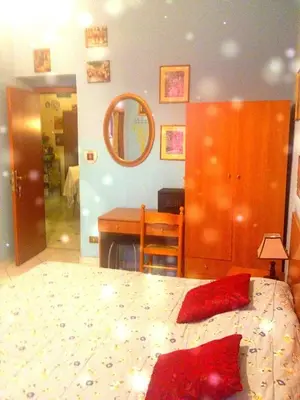 a bedroom with a bed and a desk and a mirror at B&B Cappellini in Rome