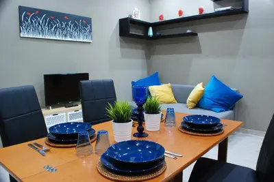 a dining room table with blue plates on it at RHOMENJOY Suite Vatican in Rome