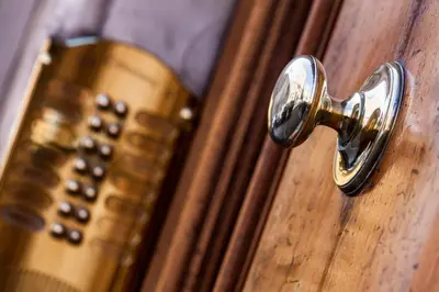 a brass door knob on a wooden door at Casa Tranquilli in Rome