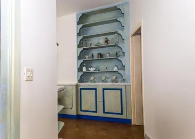 a room with a blue shelf with vases on it at Casa Tranquilli in Rome