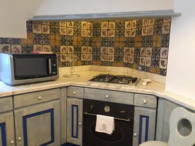 a kitchen with a stove and a microwave at Casa Tranquilli in Rome