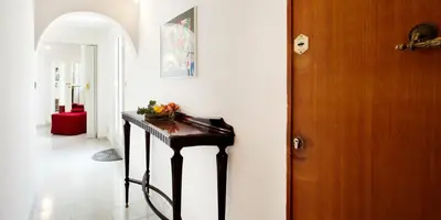 a hallway with a table in a room at Trastevere Station Terrace in Rome