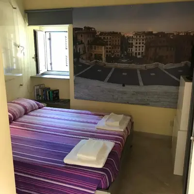 a bedroom with a white bed and a window at Piazza di Spagna Prestige in Rome