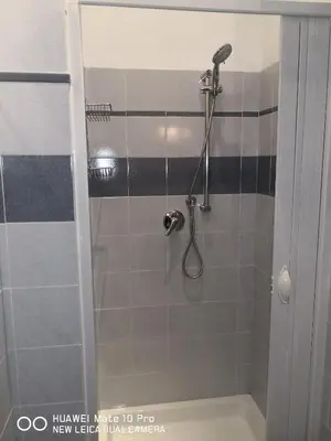 a bathroom with a shower with a shower head at Trastevere four seasons Glorioso in Rome