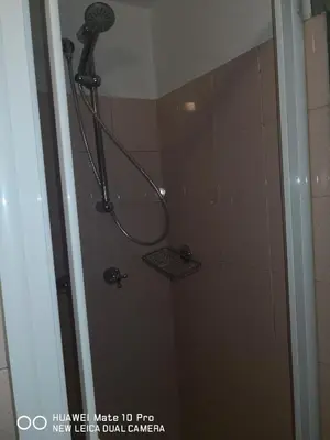 a shower with a shower head in a bathroom at Trastevere four seasons Glorioso in Rome