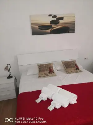 a bedroom with a bed with towels on it at Trastevere four seasons Glorioso in Rome