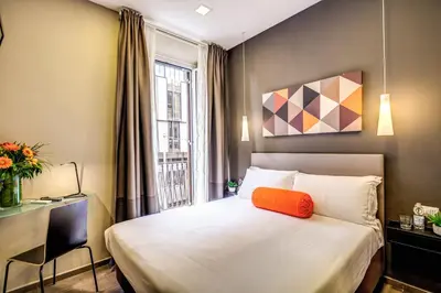 a hotel room with a bed and a window at H501 Luxury Rooms in Rome