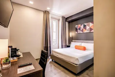 a hotel room with a bed and a desk at H501 Luxury Rooms in Rome