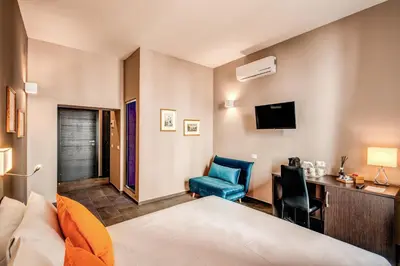 a hotel room with a bed and a desk and a chair at H501 Luxury Rooms in Rome