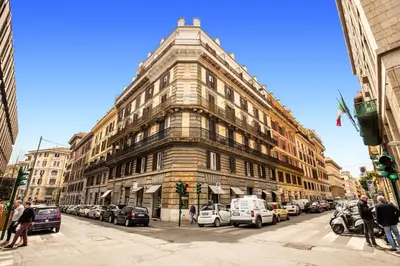 a tall building on a city street with cars parked at H501 Luxury Rooms in Rome