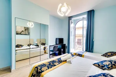 a bedroom with two beds and a mirror at Hotel Terminal in Rome