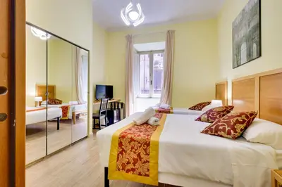 a hotel room with a bed and a mirror at Hotel Terminal in Rome