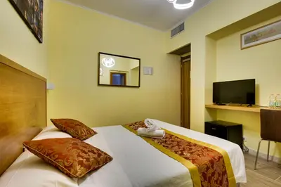 a hotel room with two beds and a television at Hotel Terminal in Rome