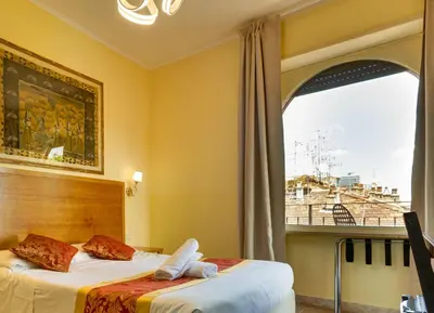 a bedroom with two beds and a large window at Hotel Terminal in Rome