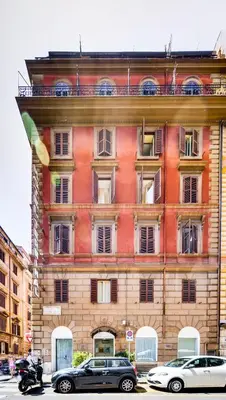 a large brick building with cars parked in front of it at Hotel Terminal in Rome