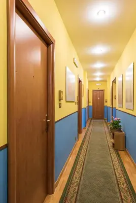 a corridor of a hospital hallway with blue and yellow walls at Alessandro A San Pietro Best Bed in Rome
