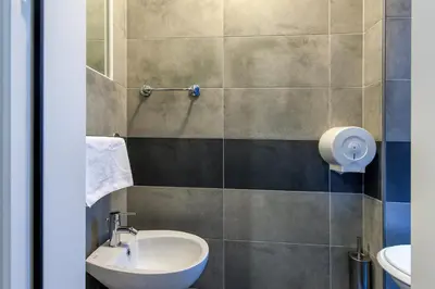 a bathroom with a sink and a toilet at Alessandro A San Pietro Best Bed in Rome