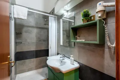 a bathroom with a sink and a shower at Alessandro A San Pietro Best Bed in Rome