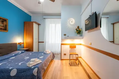 a bedroom with a bed in a room with blue walls at Alessandro A San Pietro Best Bed in Rome