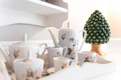 a shelf with three tea cups and a christmas tree at Pantheon Luxury House in Rome